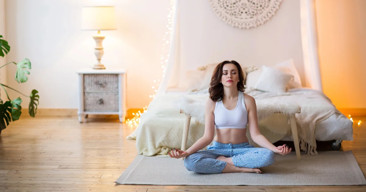Femme en méditation, assise en posture confortable, illustrant la respiration consciente.
